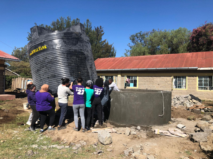 SLT team members place water tank into the foundation. Photo by Indee Thotawattage.